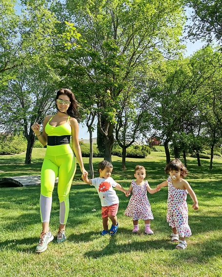 Showing off the outfits with her daughter and the twins.